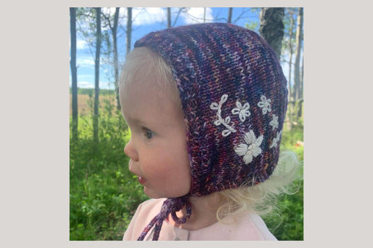 Childs hat showing embroidering on knitwear