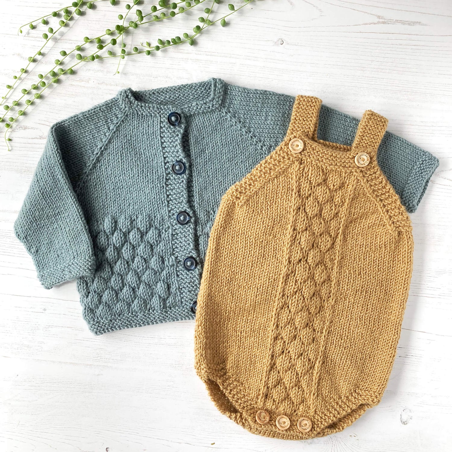 photo of a baby cardigan and matching romper which are best selling knitting patterns