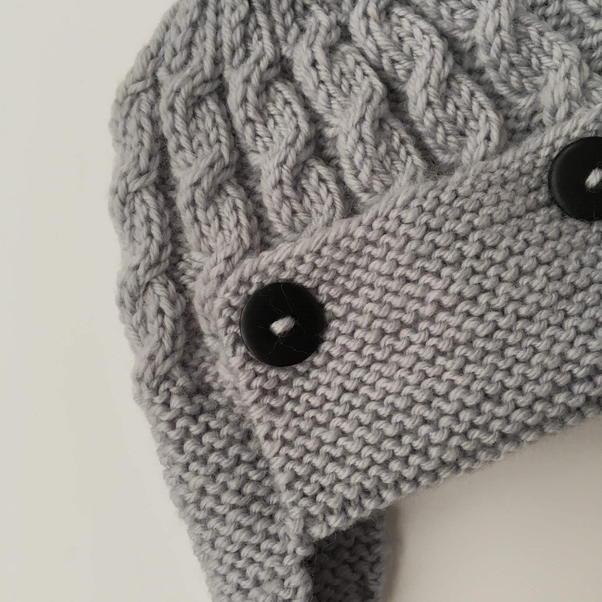 close up photo of the knitted cable design for this aviator hat pattern