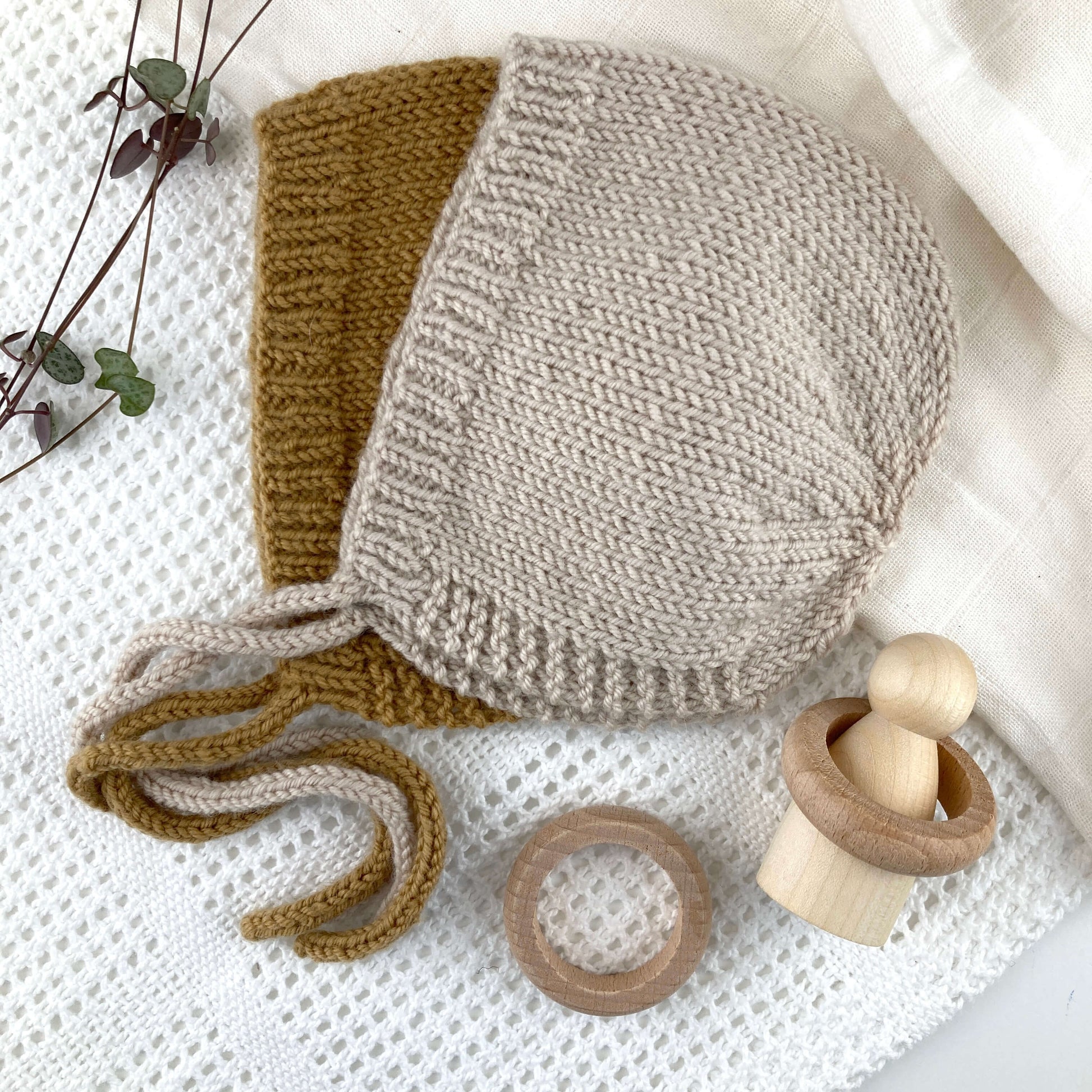 flatlay showing bonnets for an easy baby bonnet knitting pattern