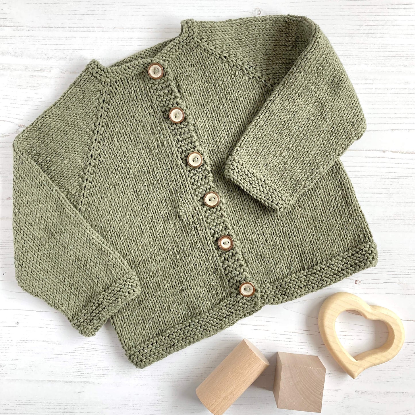 baby cardigan beginner knitting pattern sample knitted in green yarn