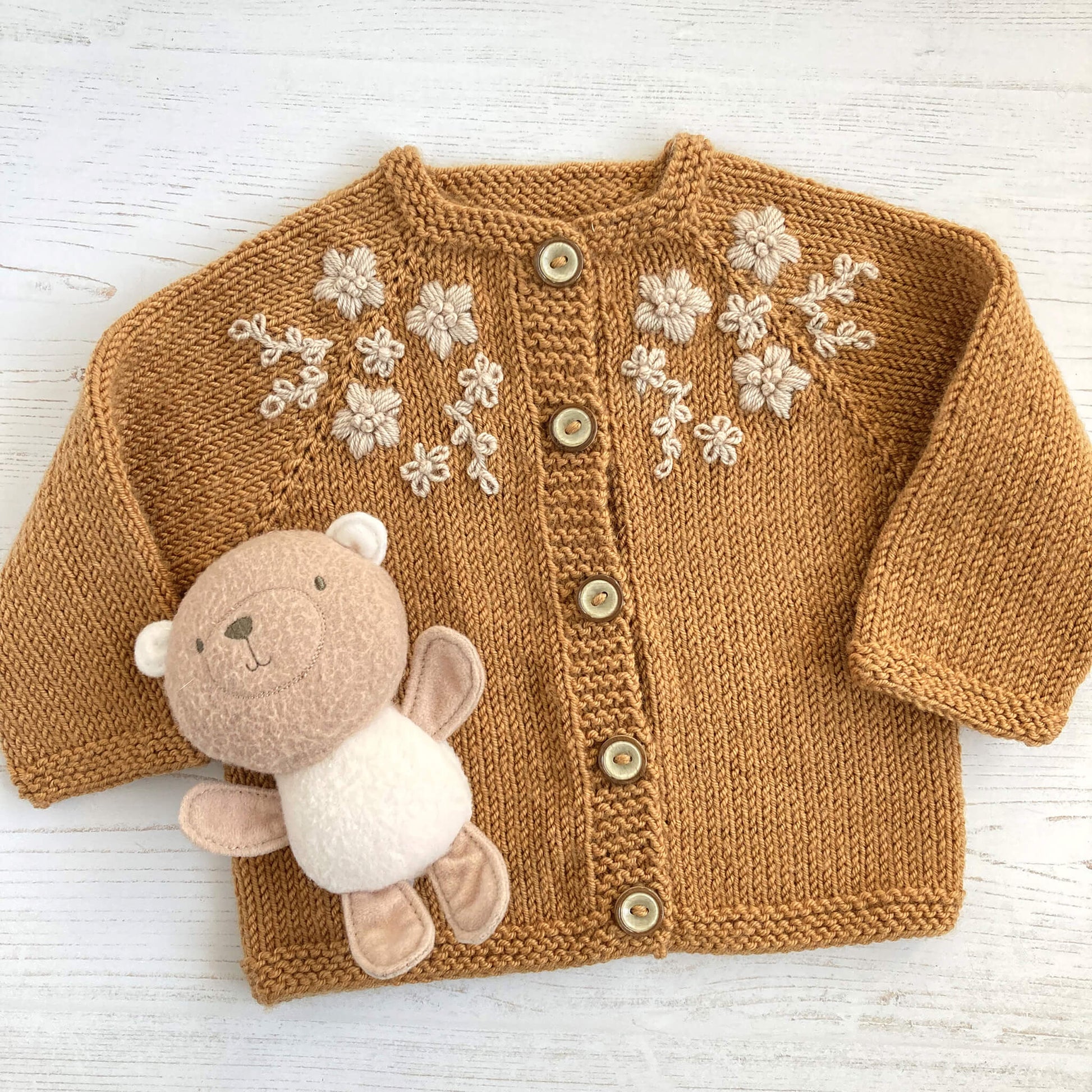 a baby cardigan knit pattern with embroidery