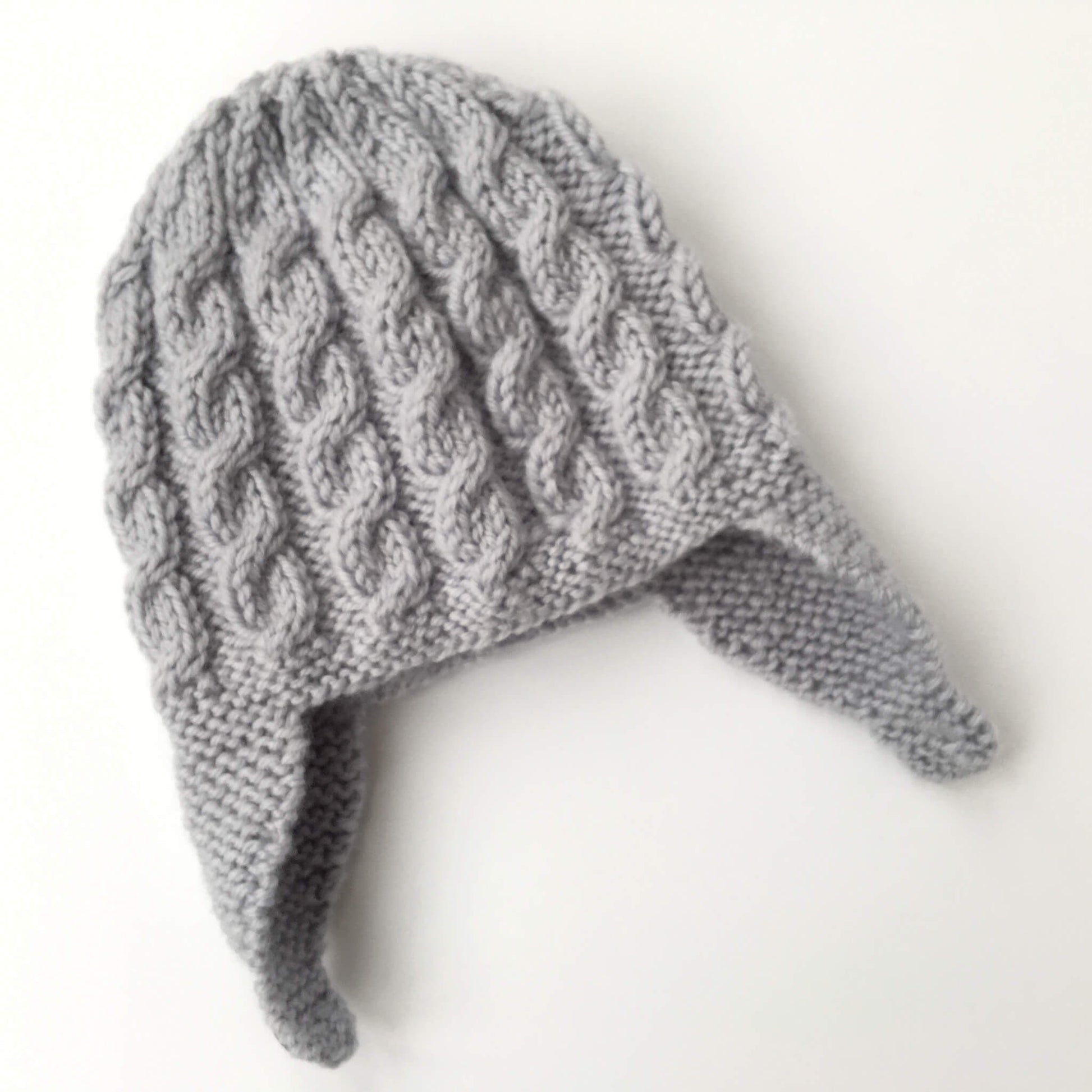 a baby hat knitting pattern with cables