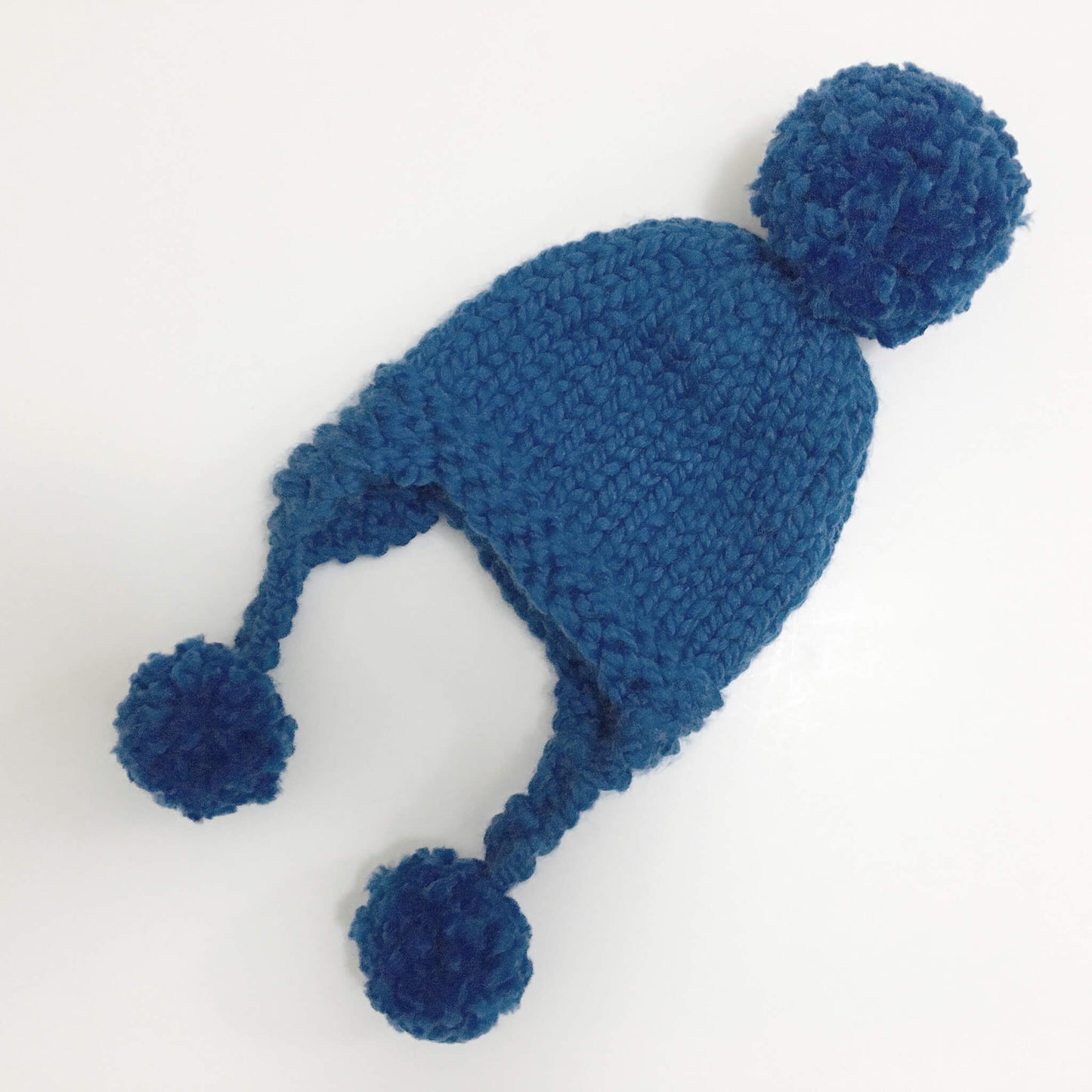 a baby hat pattern knit in chunky yarn, shown in blue