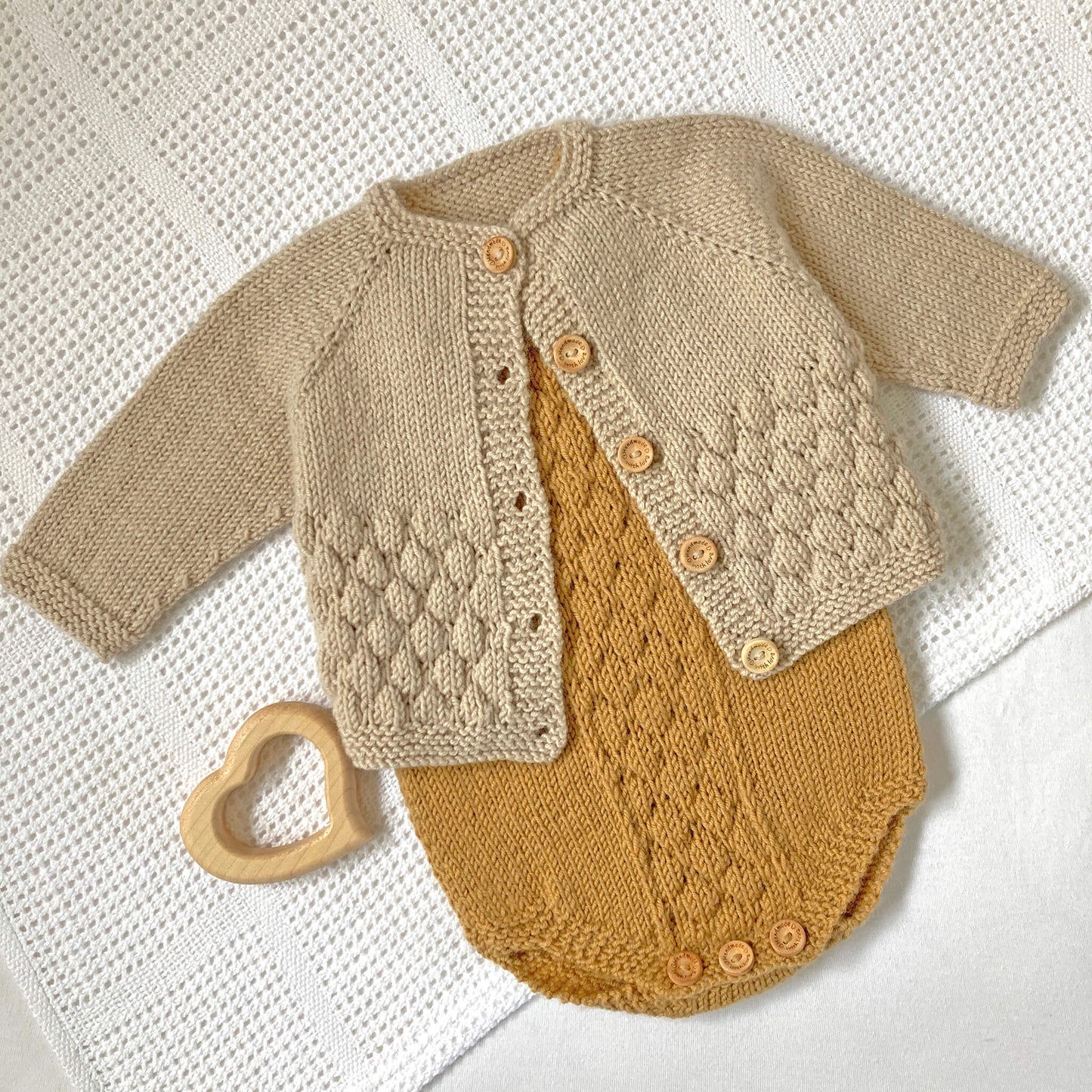 baby knit patterns in bubble stitch for a cardigan and romper