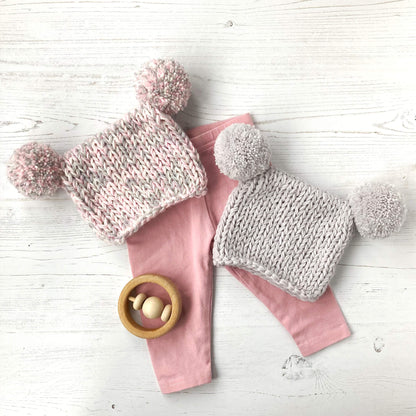 beginner baby hat knitting pattern. Two hats shown styled with a pair of pink leggings