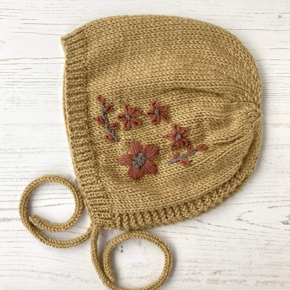 knitted baby bonnet pattern with flower embroidery