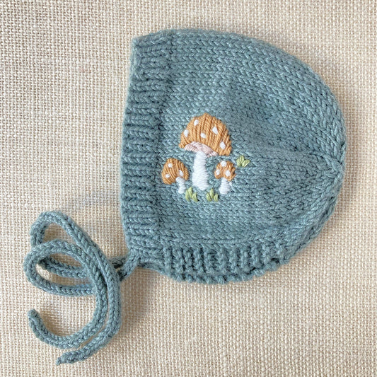 a bonnet knitting pattern with mushroom embroidery