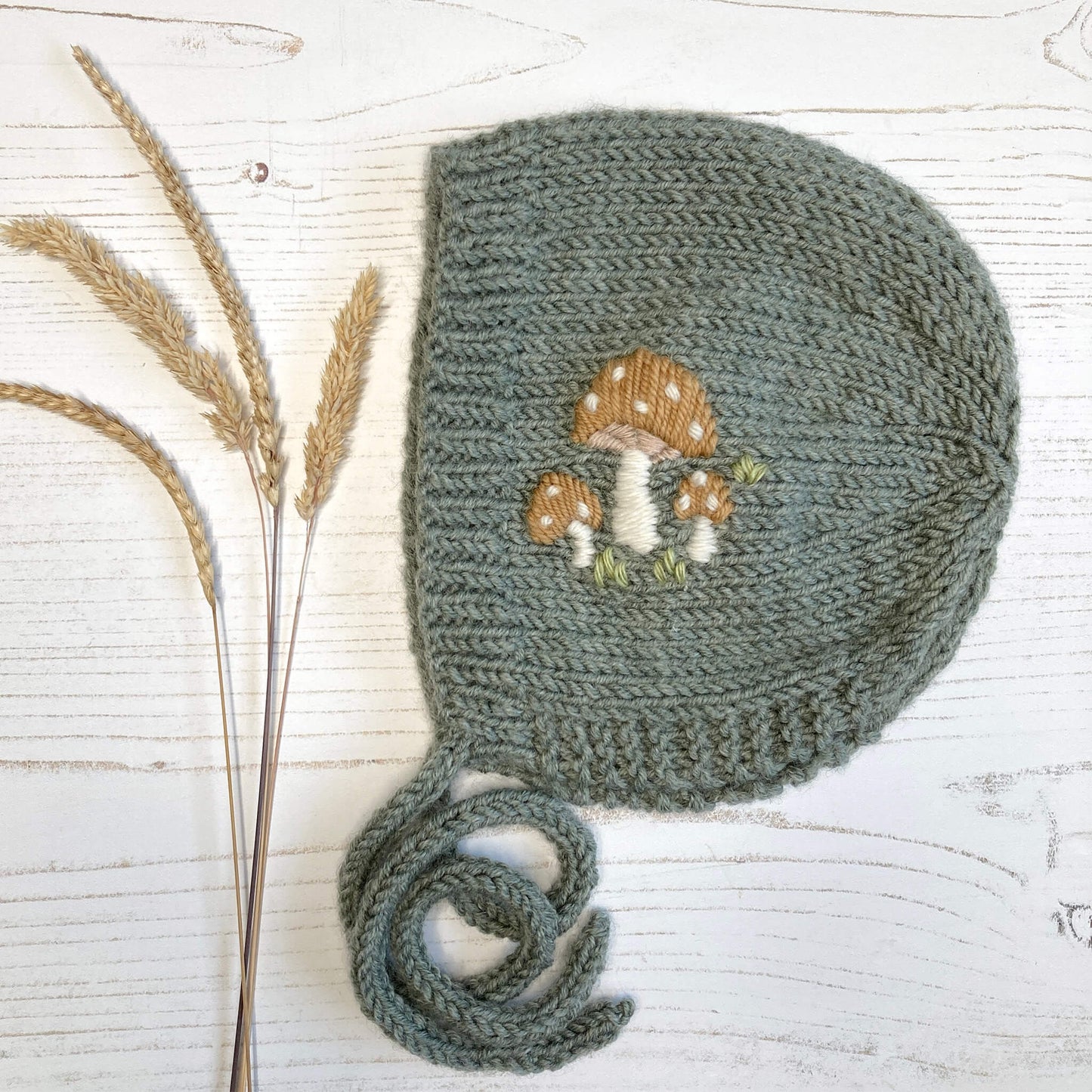 a bonnet knitting pattern with toadstool embroidery