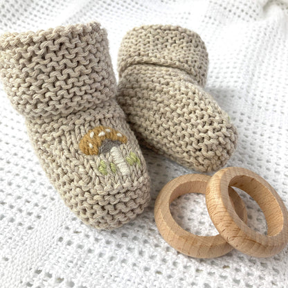 a baby booties knit pattern with toadstool embroidery