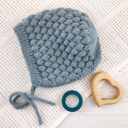 Bubble stitch bonnet knitting pattern shown in blue