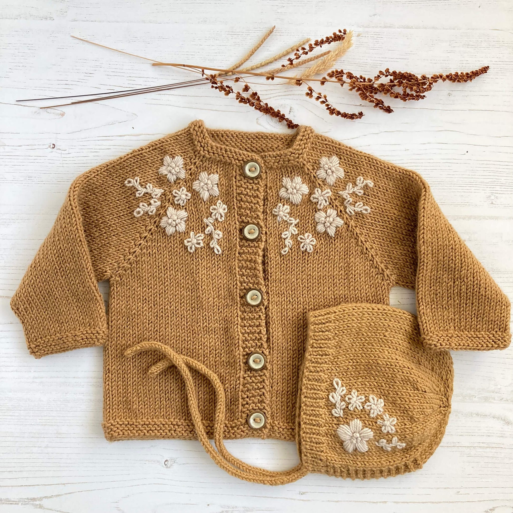 a knitting pattern with embroidery for a baby cardigan and matching bonnet