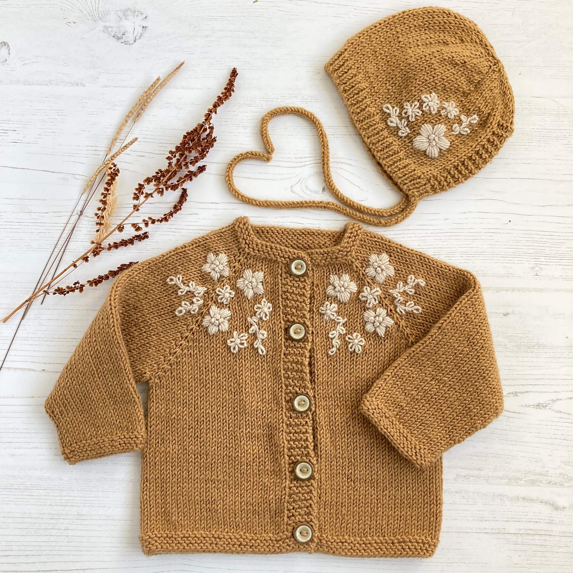 a baby cardigan and matching bonnet knitting pattern with flower embroidery