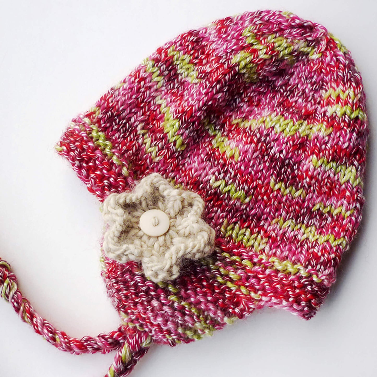 a chunky weight earflap hat knitting pattern with optional flower