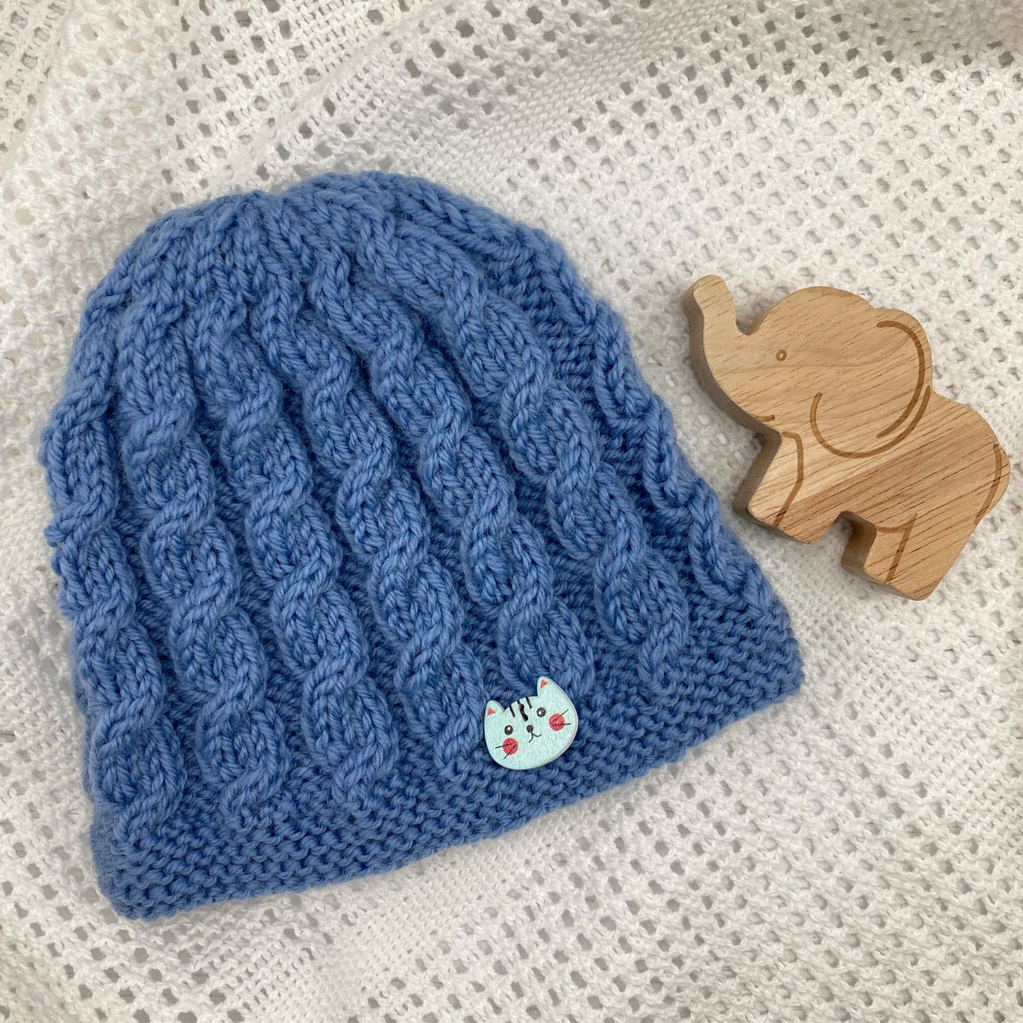 an easy knitting pattern for a baby hat with cables