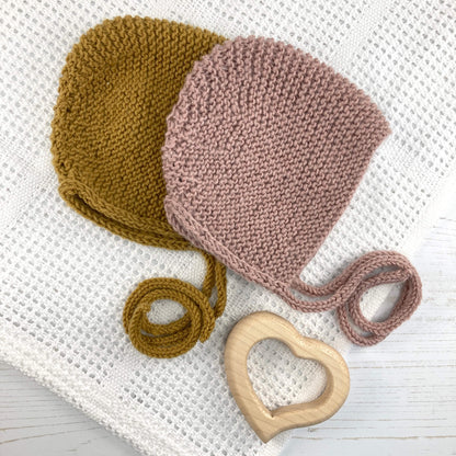 A photo showing a knitting pattern for a garter stitch baby bonnet 