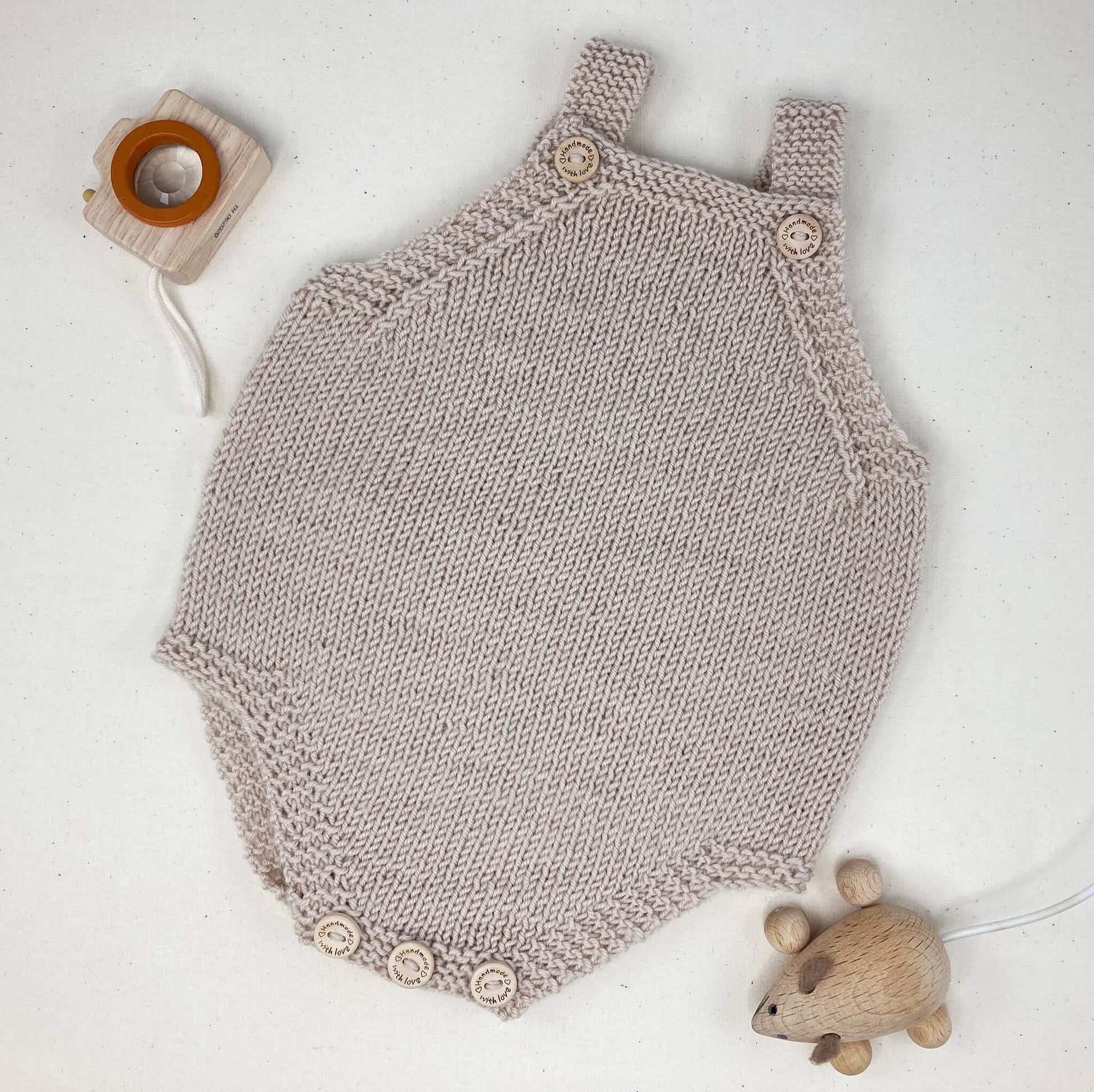 a light grey baby romper sample for a knit baby romper pattern