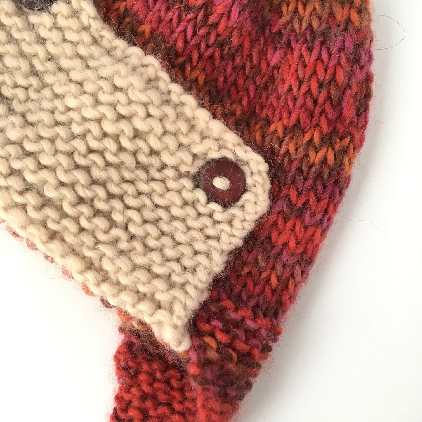 a close up photo showing the detail on a baby aviator hat knitting pattern