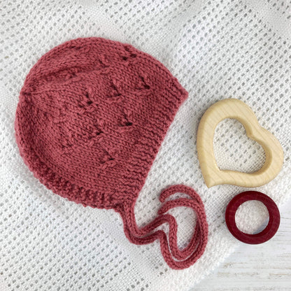 flat lay showing a knit pattern for a baby bonnet