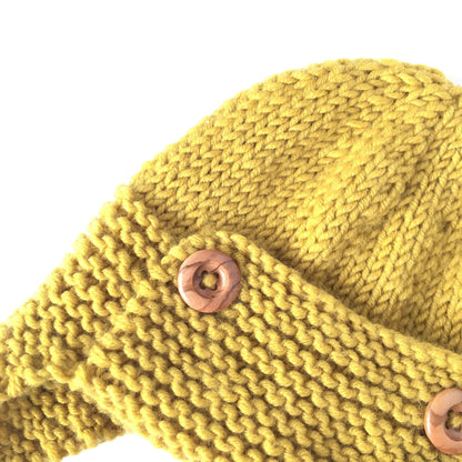 a close up photo of the detail of a knit pattern for a baby pilot hat