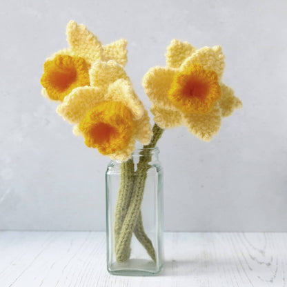 a knitted flower pattern. three knitted daffodils are shown in a vase