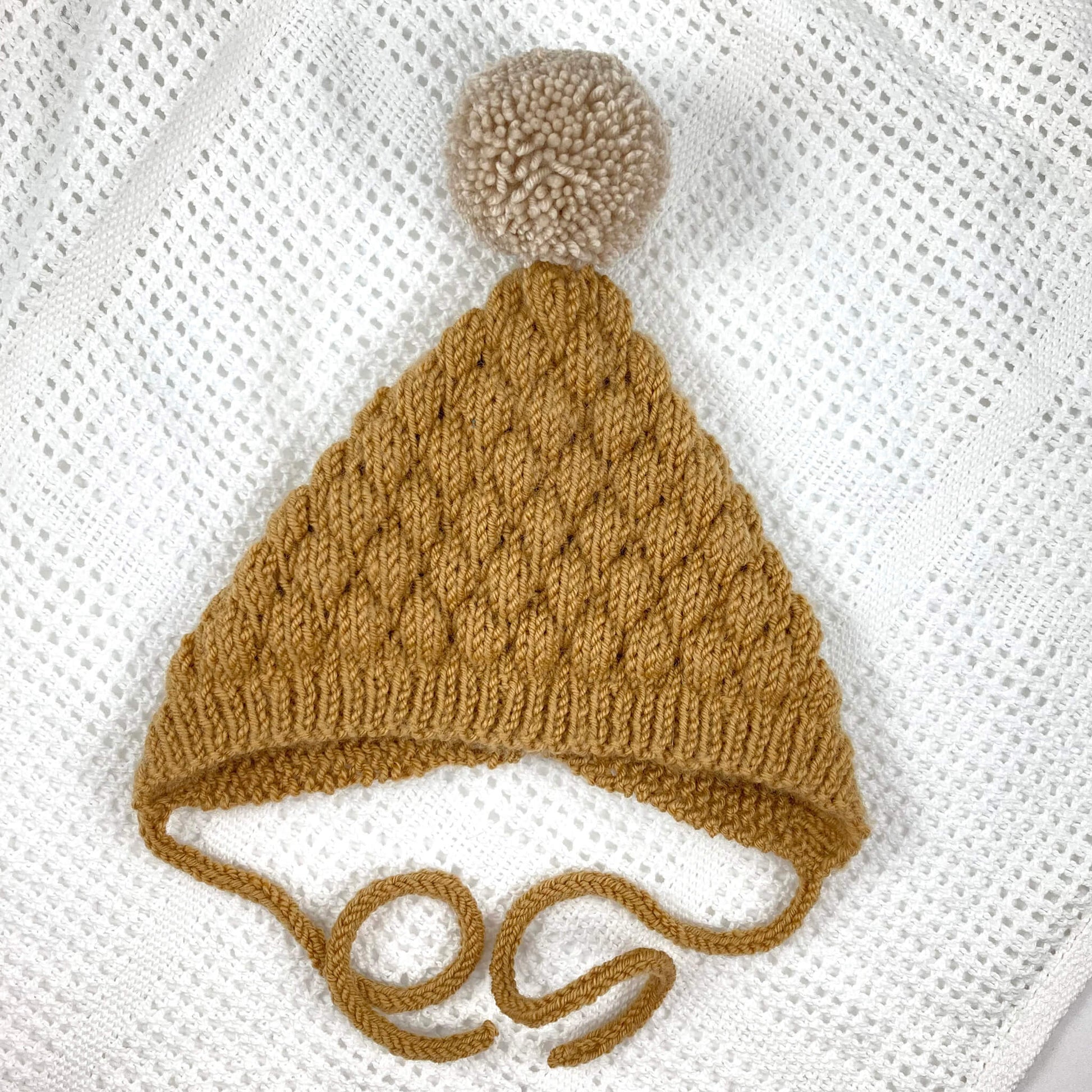 a knitting pattern for a pixie bonnet