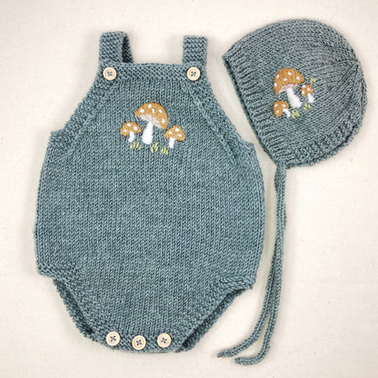 a knitting pattern for a baby romper and matching bonnet with toadstool embroidery