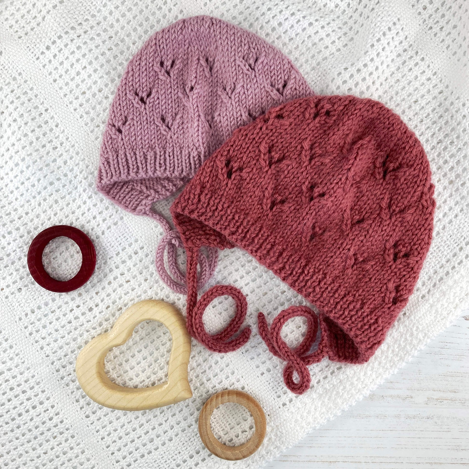 photo showing 2 baby bonnets for a lace bonnet knitting pattern