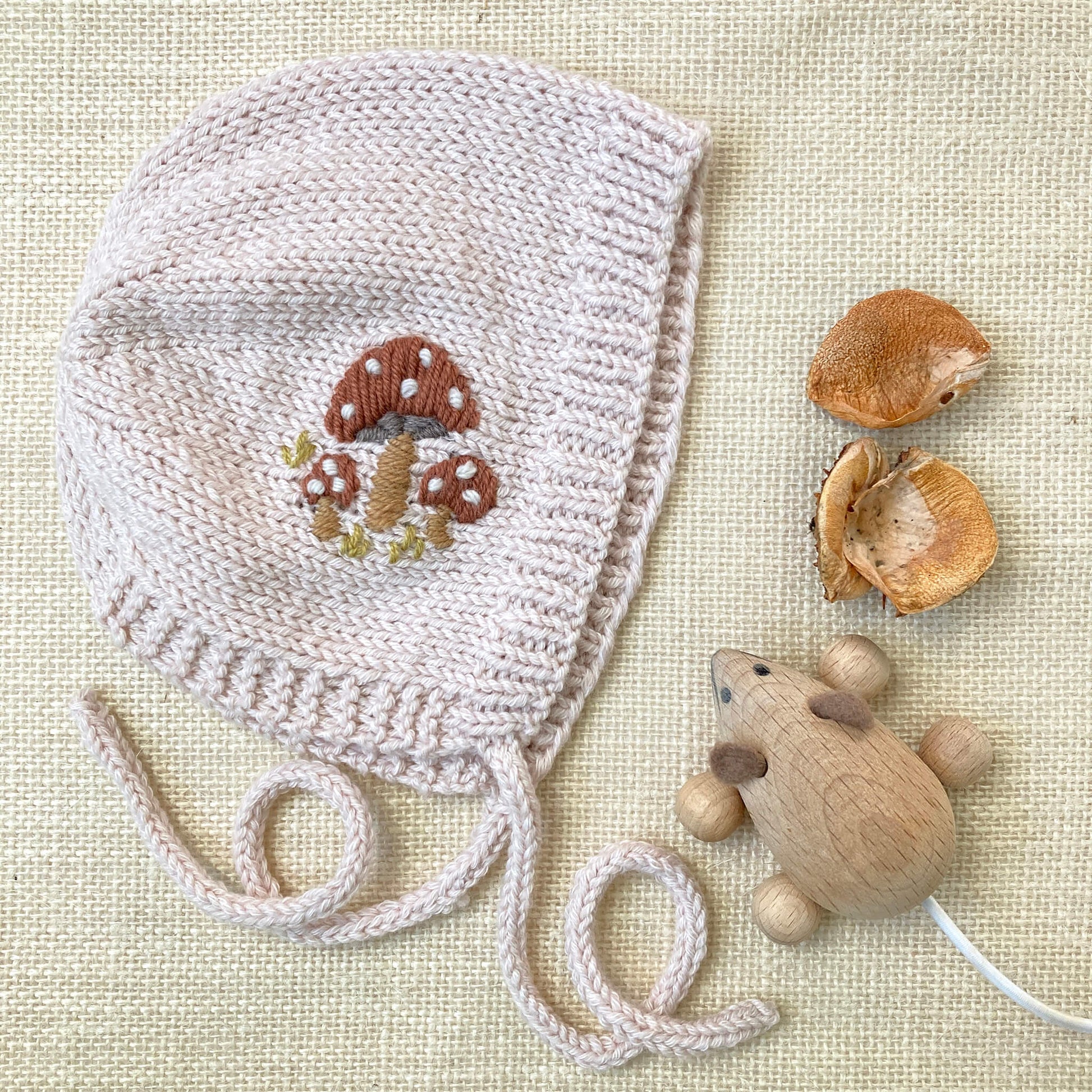 a mushroom embroidered baby bonnet knitting pattern