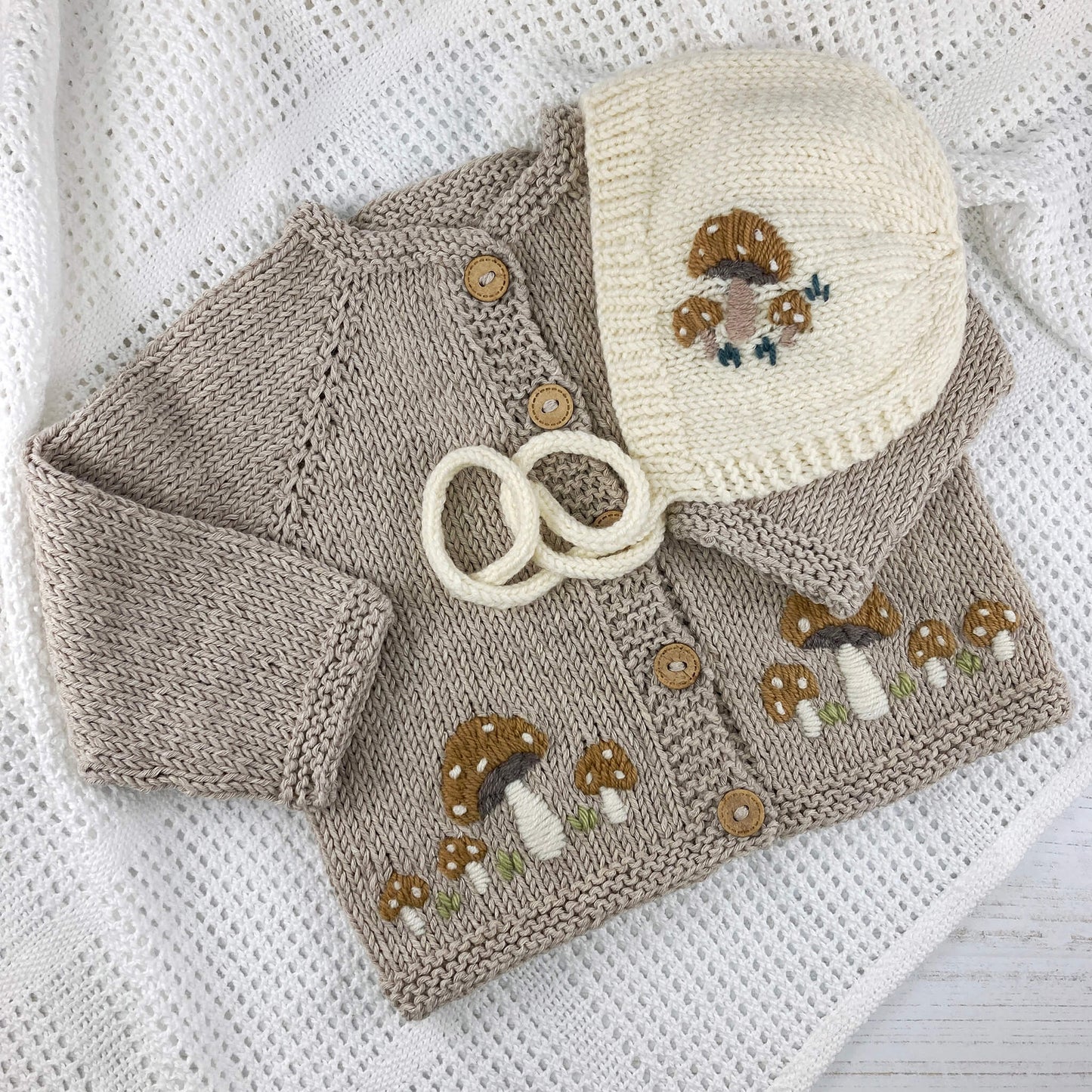 mushroom embroidered baby knitting patterns for a baby cardigan and bonnet