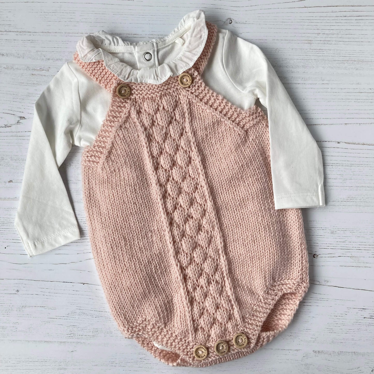 baby romper suit pattern sample knit in pink yarn