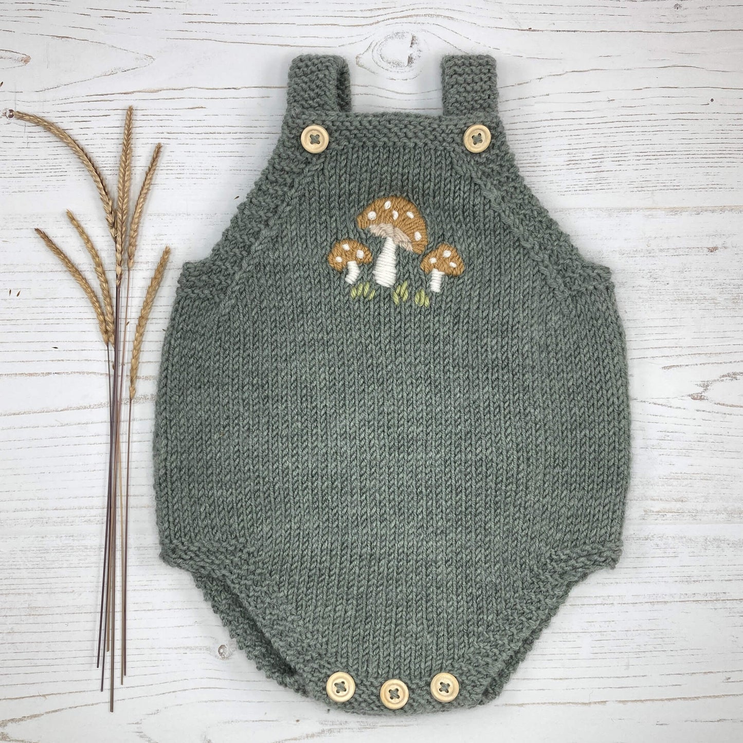 a romper knitting pattern with mushroom embroidery