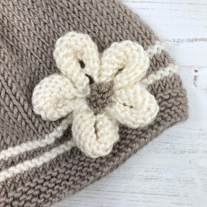 a close up view of the flower embellishment on a baby hat