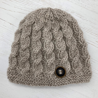 A baby hat knitting pattern with simple cables