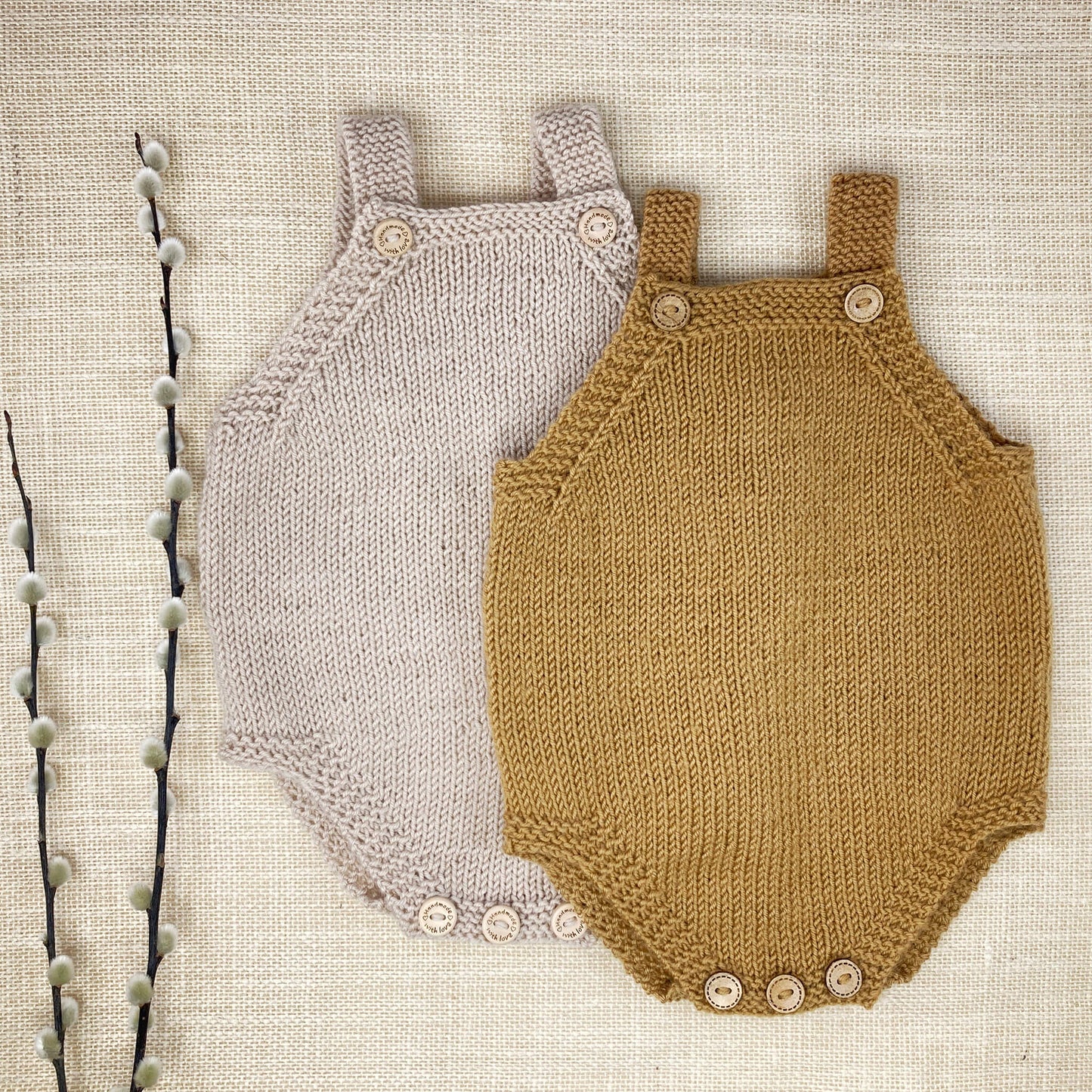 a flatlay showing two baby rompers for a simple knitting pattern