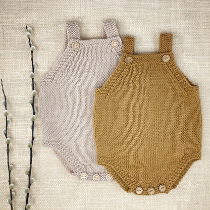 a flatlay showing two baby rompers for a simple knitting pattern