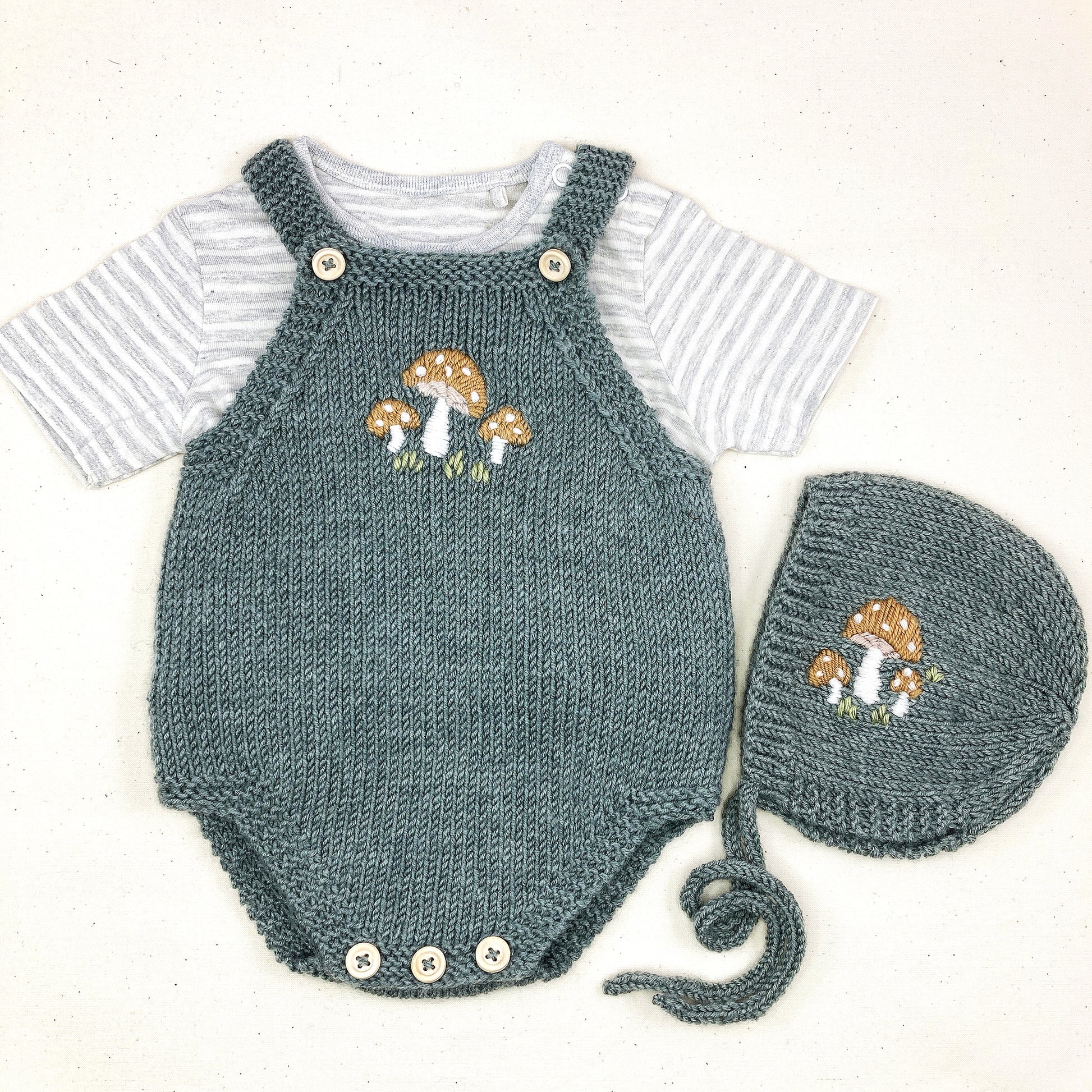 a toadstools embroidered baby romper and bonnet for a knitting pattern