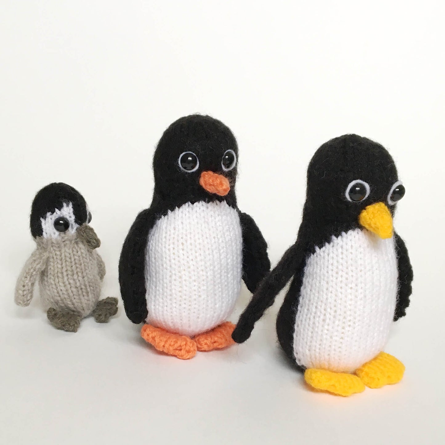 a toy penguin knitting pattern. three pengins shown, 2 adults and one baby